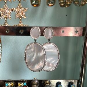 Mother of pearl oval hanging earrings.